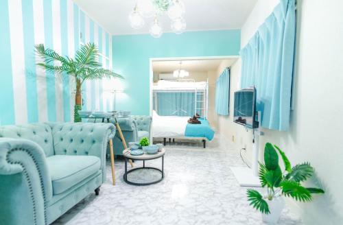 a blue living room with a couch and a bed at LEON RESORT HOTEL Max 9 people 3 min taxi Ikebukuro Station Tiffany Blue yellow Room 最大9名 池袋 in Tokyo