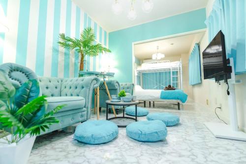 a living room with blue furniture and a tv at LEON RESORT HOTEL Max 9 people 3 min taxi Ikebukuro Station Tiffany Blue yellow Room 最大9名 池袋 in Tokyo