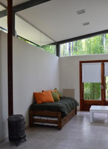 a bedroom with a bed in a room with windows at Casa Puentes Amarillos in Malargüe