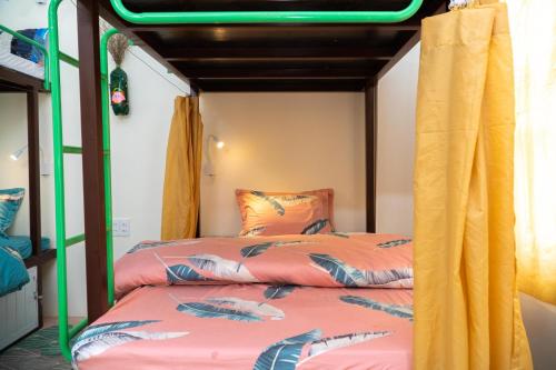 two beds in a room with a bunk bed at Pao's Leisure Homestay in Ha Giang