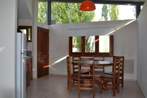a dining room with a table and some chairs at Casa Puentes Amarillos in Malargüe