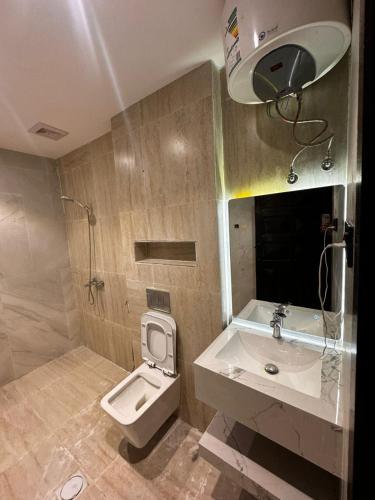 a bathroom with a toilet and a sink at روح المدينة السكنية in Medina