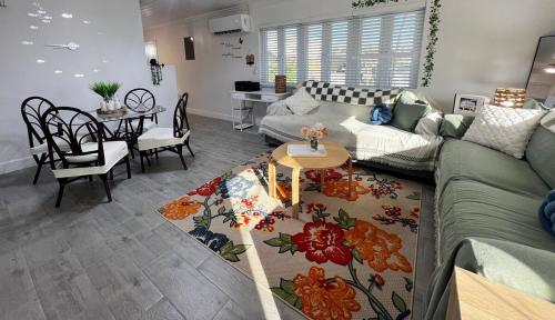 a living room with a couch and a table at All Decked Out, Exuma in Georgetown