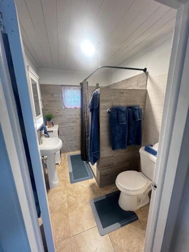 a small bathroom with a toilet and a sink at All Decked Out, Exuma in Georgetown