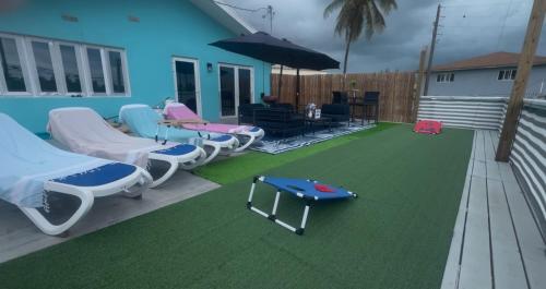 a deck with chairs and a ping pong table at All Decked Out, Exuma in Georgetown