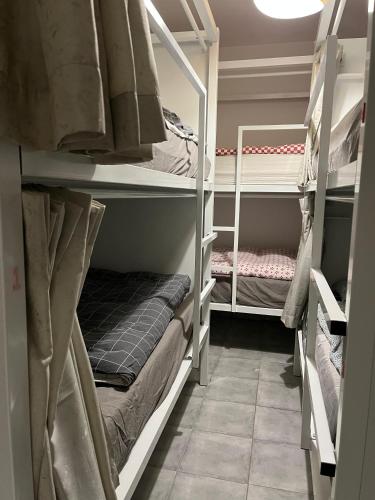 a room with several bunk beds in a room at SwissPorto Guest House in Porto