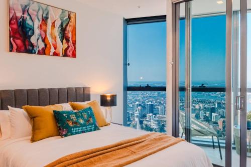 a bedroom with a bed and a large window at Sky Palace — Luxe Queen’s Wharf Apt + Carpark in Brisbane