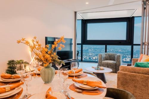 a dining room with a table with wine glasses at Sky Palace — Luxe Queen’s Wharf Apt + Carpark in Brisbane