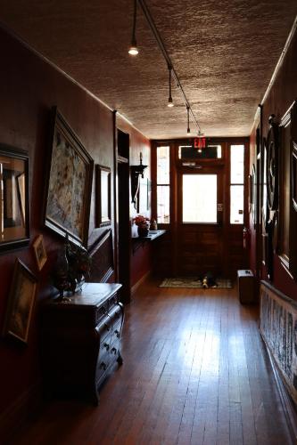 a living room with a wooden floor and a door at The Oliver House - Adults Only in Bisbee