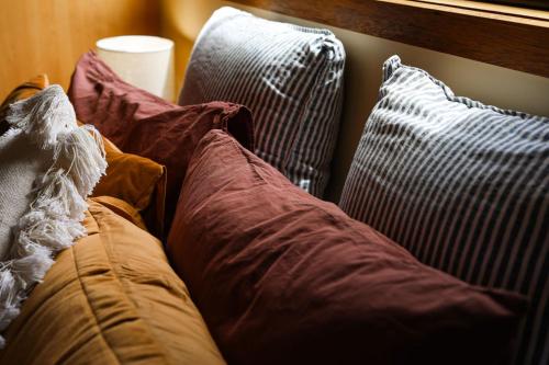 a group of pillows sitting on a couch at Red ceder cottage - Great ocean road - Port Campbell in Port Campbell