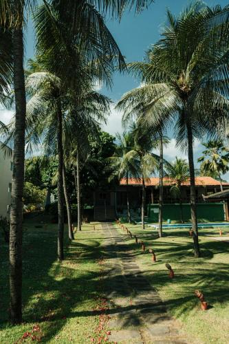 a row of palm trees in front of a building at Pecem Beach Hotel - Aval Hotel in Pecém