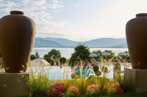 a resort with a pool and a view of the water at Limneon Resort & Spa in Kastoria