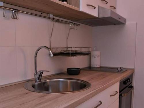 a kitchen counter with a sink in a kitchen at One Bedroom Apartment with Terrace & Garden View in Supetar