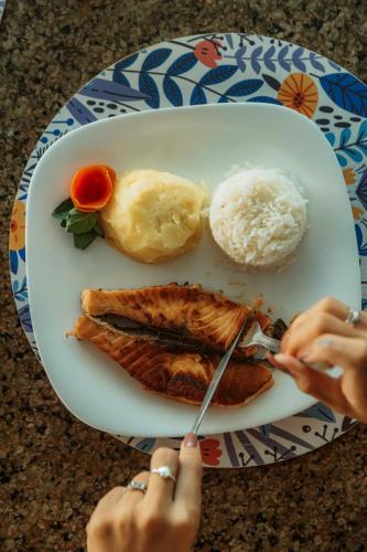 a plate of food with meat and rice on a table at Pecem Beach Hotel - Aval Hotel in Pecém