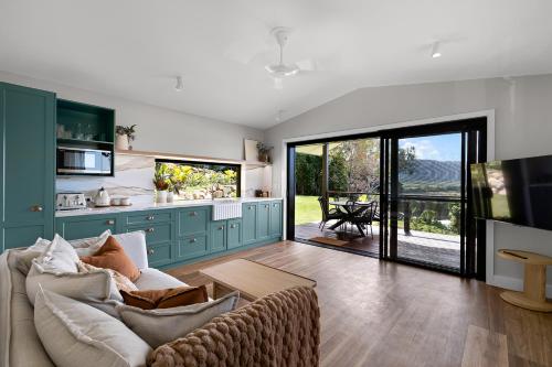 a living room with a couch and a table at Bungalow 22 in Cannon Valley