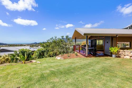 a small house with a porch and a yard at Bungalow 22 in Cannon Valley