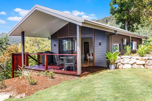 a small house with a porch and a deck at Bungalow 22 in Cannon Valley