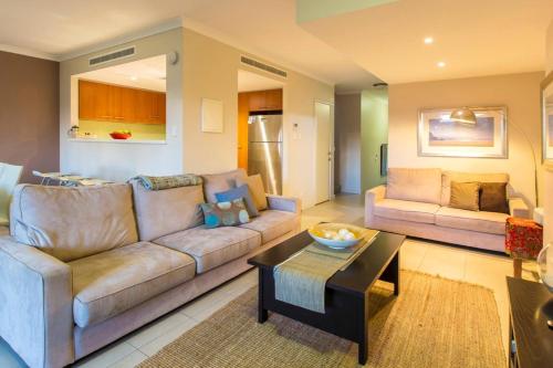 a living room with a couch and a table at Surfside 9 - In the Idyllic Yallingup Beach Scene in Yallingup