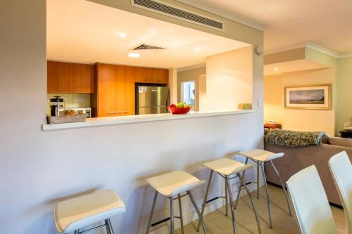 a living room with a table and stools at Surfside 9 - In the Idyllic Yallingup Beach Scene in Yallingup