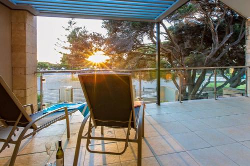 a pair of chairs on a balcony with a view of the water at Surfside 9 - In the Idyllic Yallingup Beach Scene in Yallingup