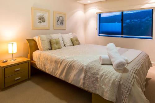 a bedroom with a large bed and a window at Surfside 9 - In the Idyllic Yallingup Beach Scene in Yallingup