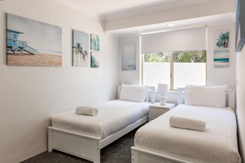 a white room with two beds and a window at Reverie By The Bay - Walk to Beaches, Relax in Style in Dunsborough