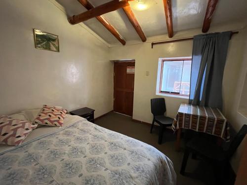 Ένα ή περισσότερα κρεβάτια σε δωμάτιο στο Intihuatana Hostel