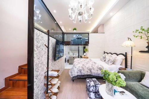 a bedroom with a bed and a couch at 柃居 B&B - Jing'an Temple Branch in Shanghai