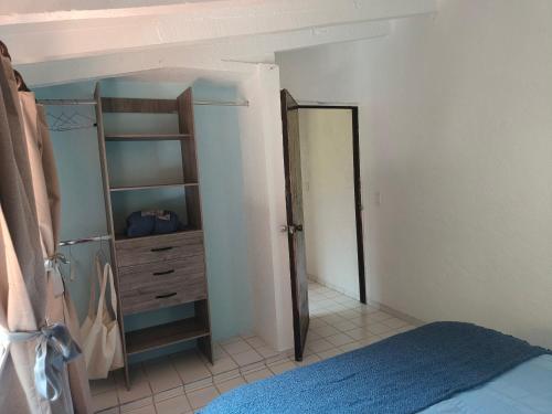 a bedroom with a bed and a dresser and a mirror at Portal Azahualco Bungalow close to the mountain in Tepoztlán