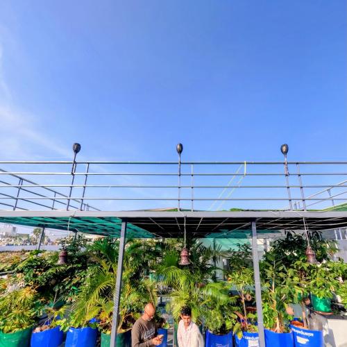 a group of people standing under a tent with plants at CHOUDHARY WHITE HOUSE Udaipur in Udaipur