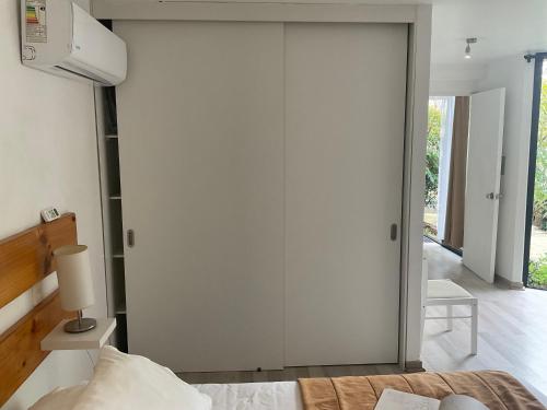 a bedroom with a sliding closet door and a bed at Lomas Loft in Santiago