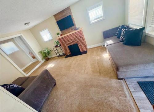 a living room with a couch and a fireplace at Comfy 3 Bedroom entire home with cozy vibes in Akron