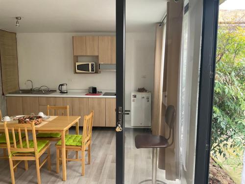a kitchen and dining room with a table and chairs at Lomas Loft in Santiago