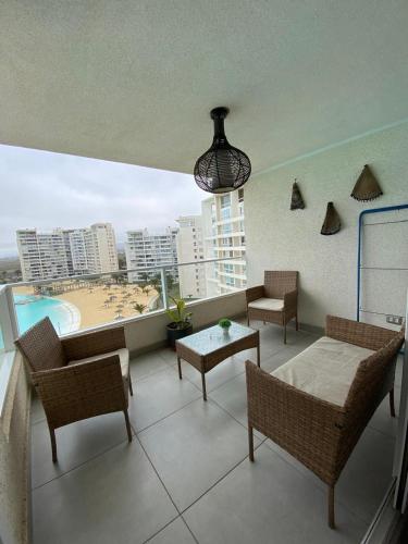 a balcony with furniture and a view of a beach at departamento con vista al mar en La Serena in La Serena
