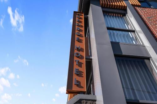 a building with a sign on the side of it at George Hotel Launceston, an Ascend Collection Hotel in Launceston