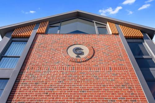 a brick building with a clock on top of it at George Hotel Launceston, an Ascend Collection Hotel in Launceston