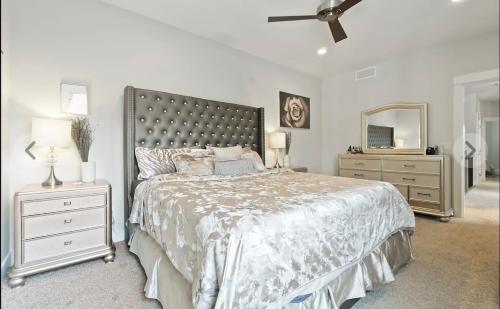 a bedroom with a large bed and a mirror at Luxury townhome in lake country in Lake Country