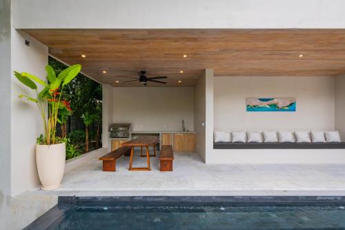 a patio with a table and a swimming pool at NEW Modern 6BR, Pool, Walk 2 Beach, Sleeps 20 in Playa Guiones