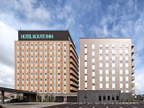 a large hotel building with a hotel route inn on it at Hotel Route-Inn Noshiro in Noshiro