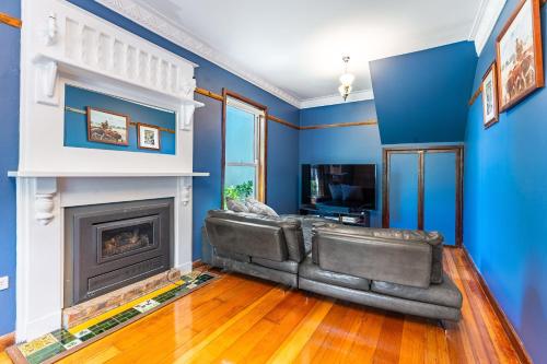 a living room with a couch and a fireplace at Central View Eco Home in Castlemaine