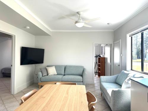 a living room with a couch and a table at SunnySide Down 23 McDonalds Place Evans Head in Evans Head