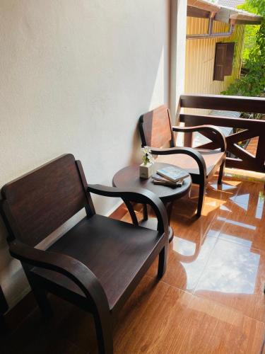 a group of chairs and tables on a patio at Nong Khiaw IVY Mountain View in Nongkhiaw