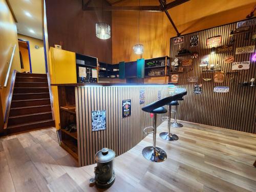 a bar with a stool in a room with a staircase at 702 Retro Cooloola Villa, Kingfisher Bay K'gari in Kingfisher Bay