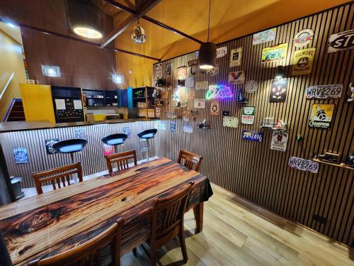 a bar with a wooden table and chairs in a room at 702 Retro Cooloola Villa, Kingfisher Bay K'gari in Kingfisher Bay