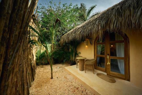 a small hut with a door and a table and chairs at Buena Vida Macao 7 habitaciones in Salado