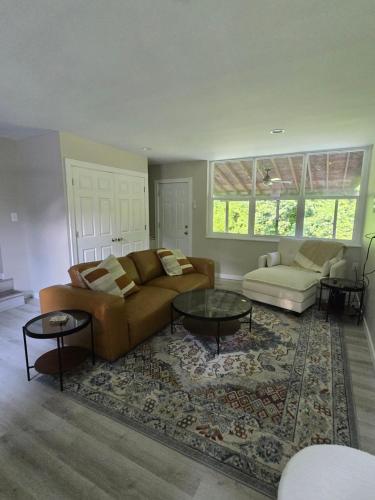 a living room with a couch and a table at MidCity Country Charm in Cincinnati