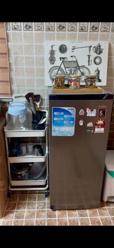 a kitchen with a small refrigerator with magnets on it at AL Rayyan Homestay KLIA SEPANG in Sepang