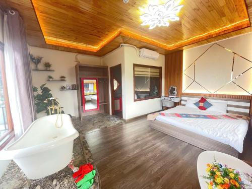 a bathroom with a bed and a tub and a sink at Alley Homestay SaPa in Sa Pa