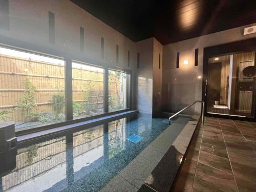 a swimming pool in the middle of a house at Hotel Route-Inn Noshiro in Noshiro