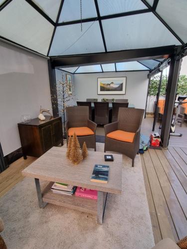 a living room with a table and a dining room at Pukeko Cottage in Richmond